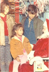 Top: Michele and Tony Wood; on Santa's lap, Karen Wood.